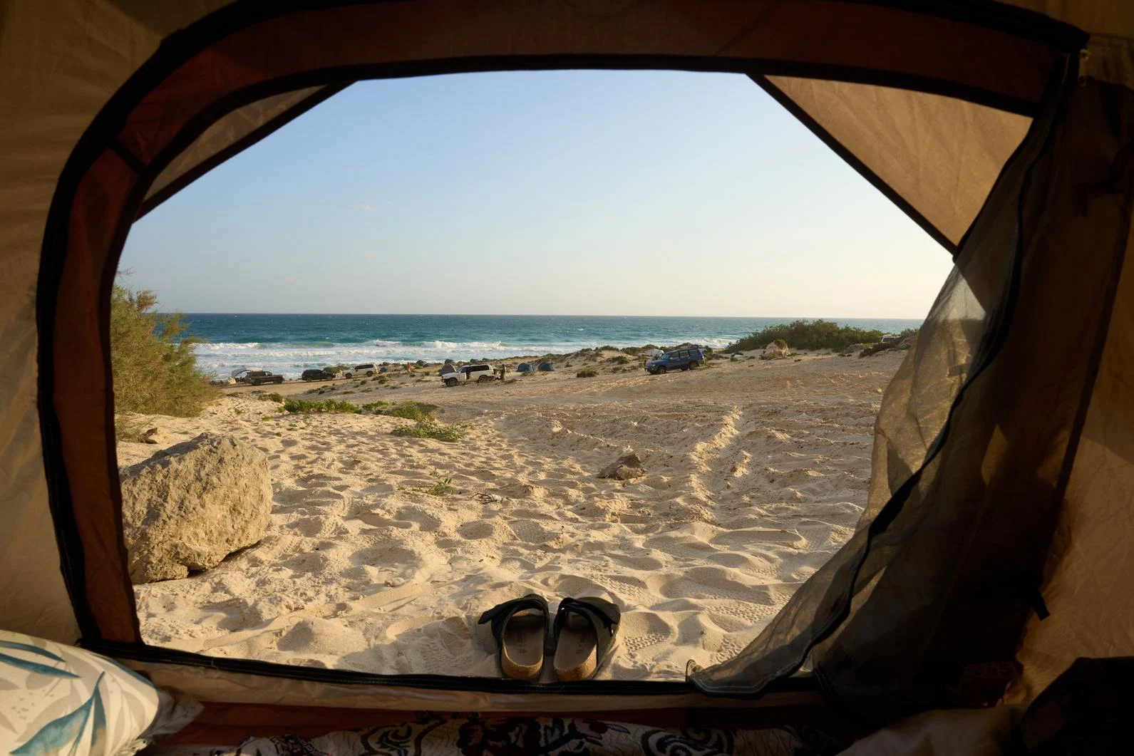 The sea viewed from the opening of a simple tent
