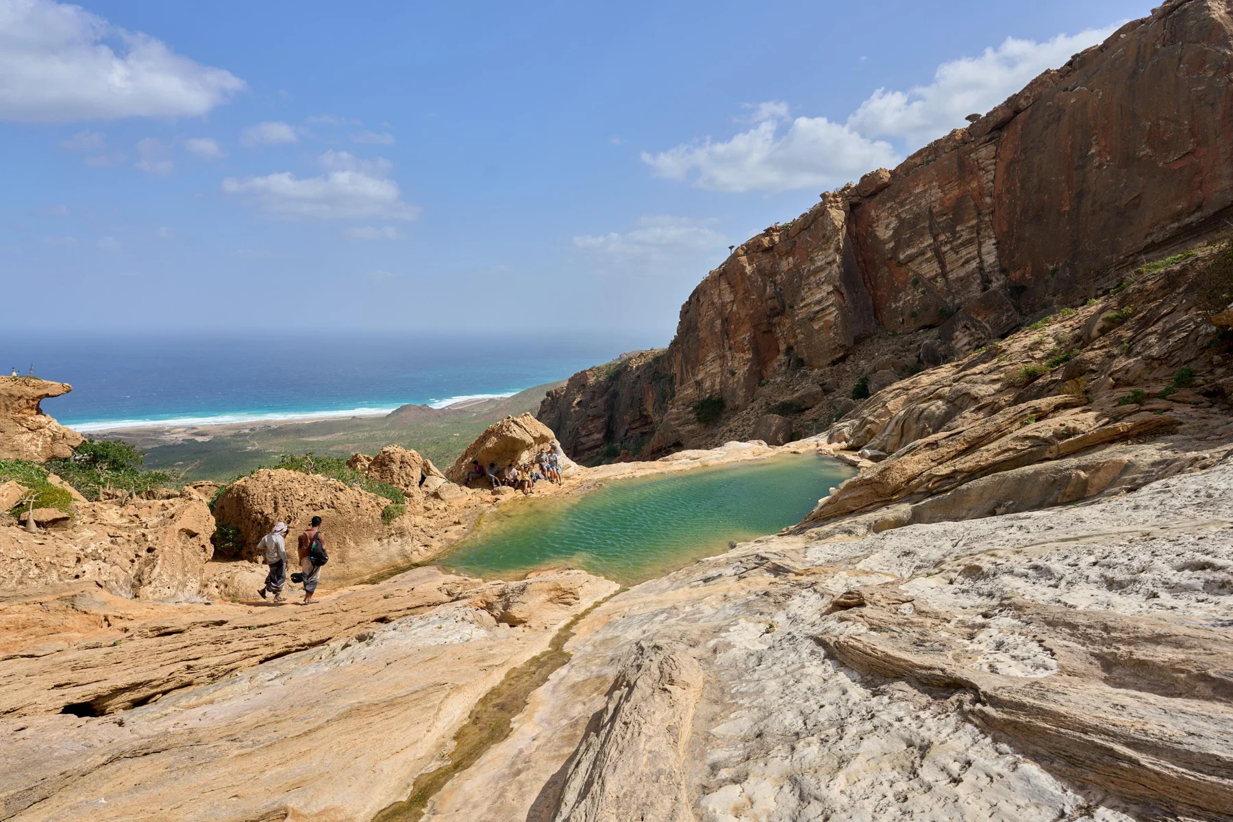 A natural pool and limestone slopes above the coast