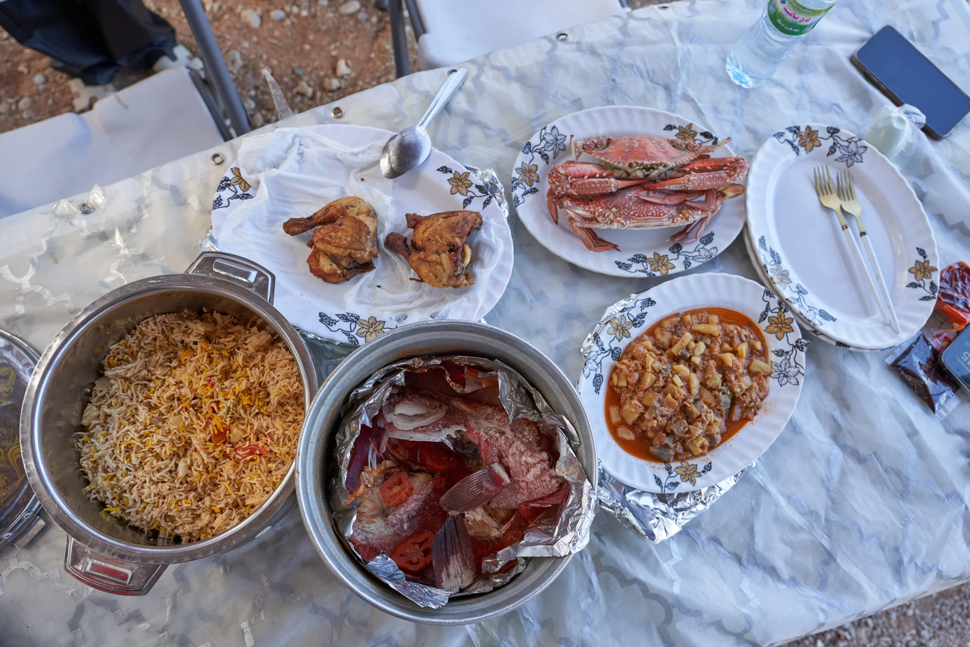 Fresh fish, crab, rice and island dishes prepared for a shared meal in Socotra
